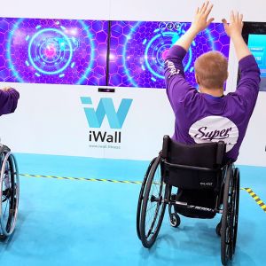 Boy in wheelchair playing iWall game