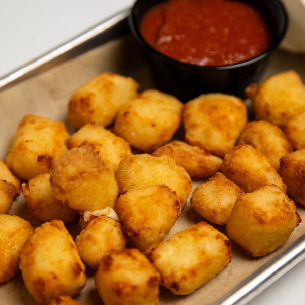Closeup view of cheese curds with marinara sauce